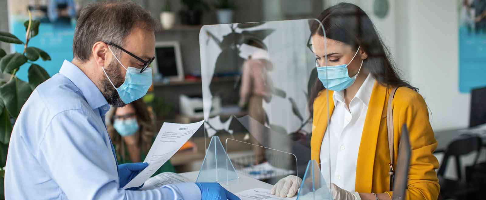 Young woman at bank while wearing a safety mask.