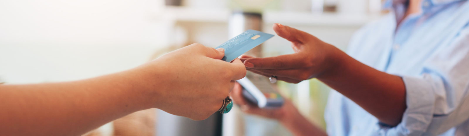 Person using debit card for a purchase.