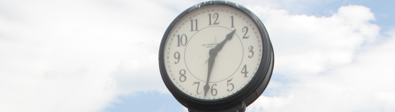 Face of clock in Bristow town square.